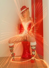 Kara in her sexy christmas outfit wrapped in lights spreading her pussy